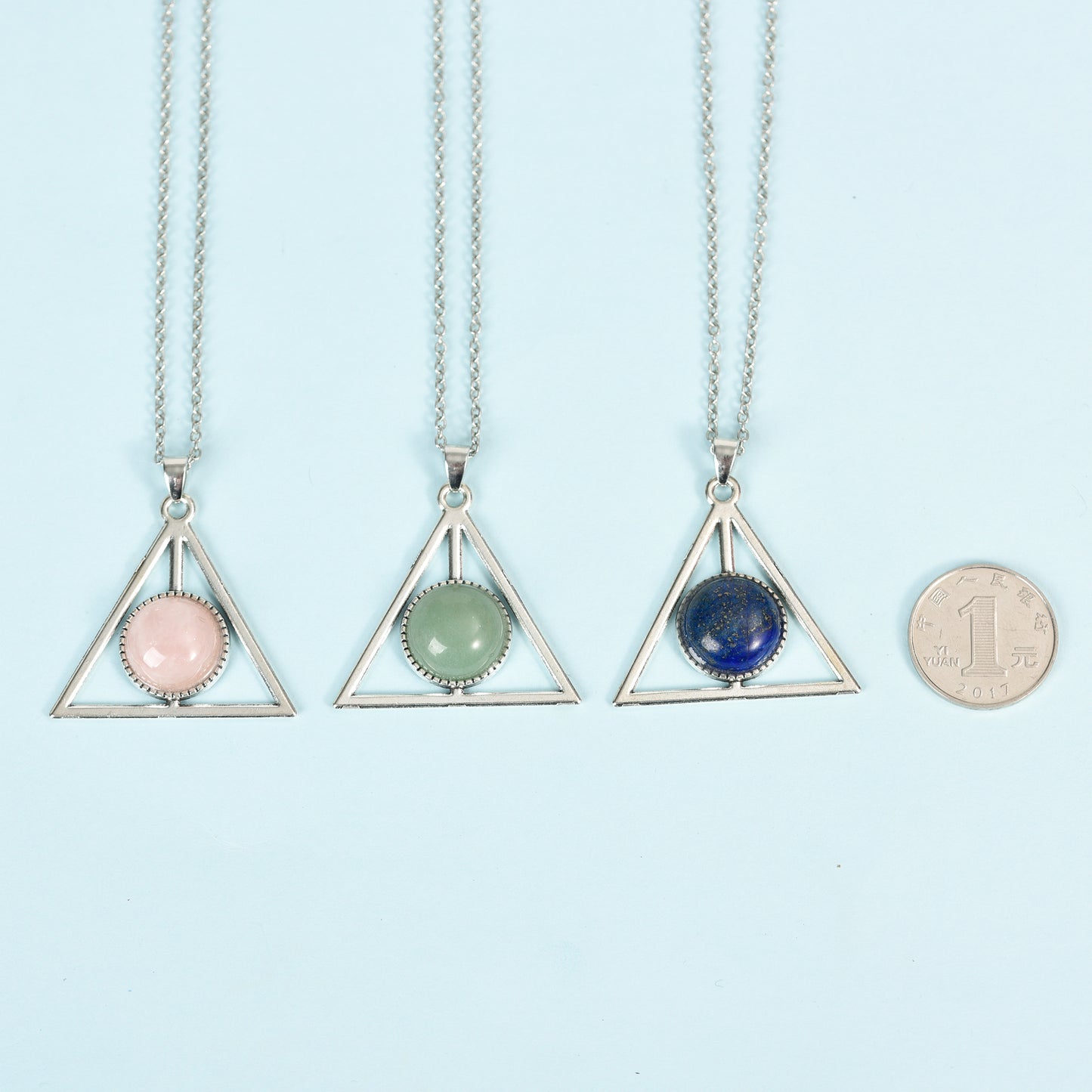 Metal triangle with round crystal pendant