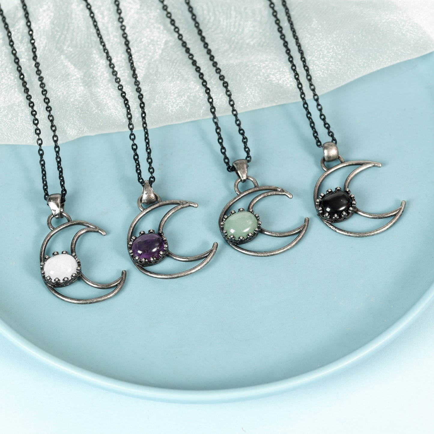 Metal moon with oval crystal pendant