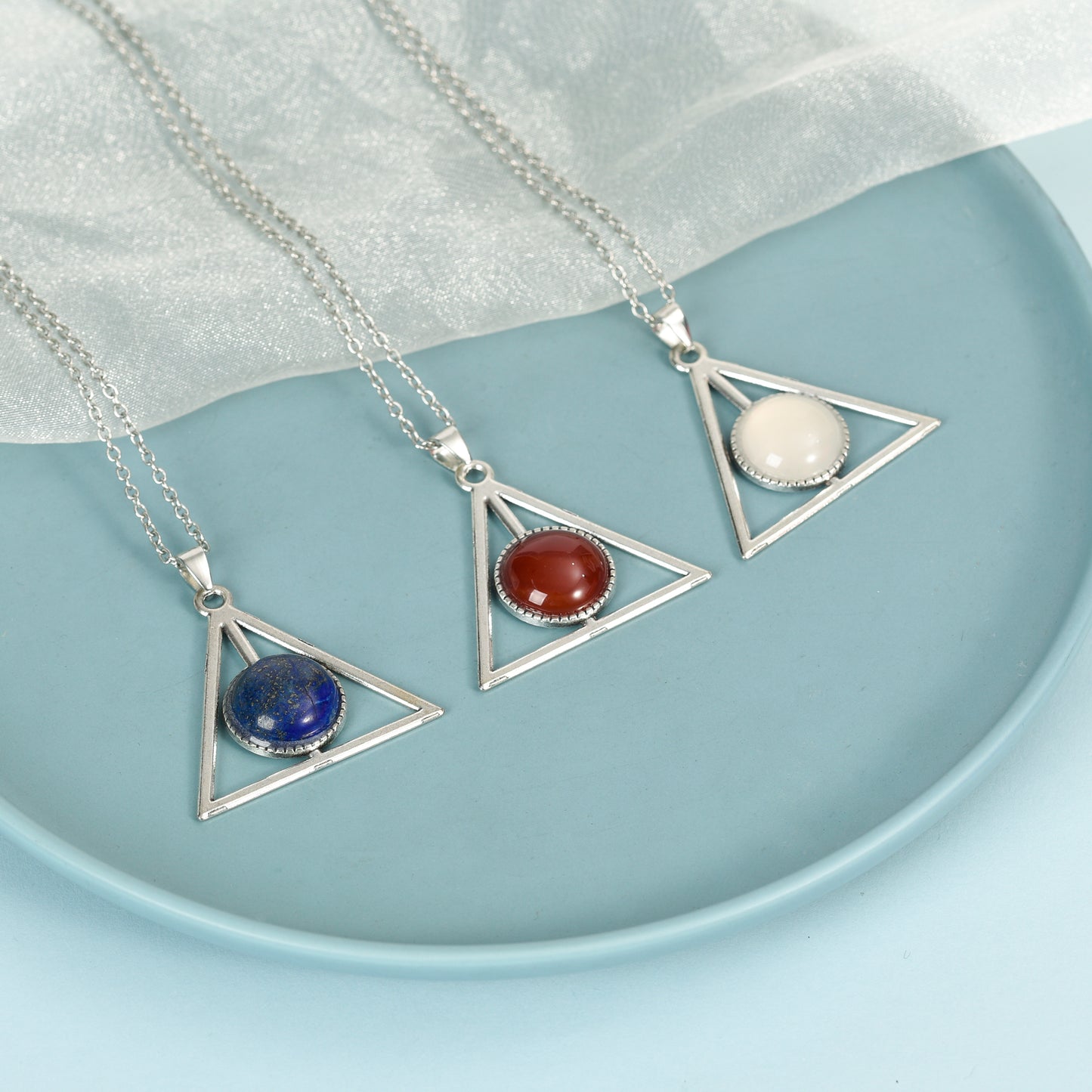 Metal triangle with round crystal pendant