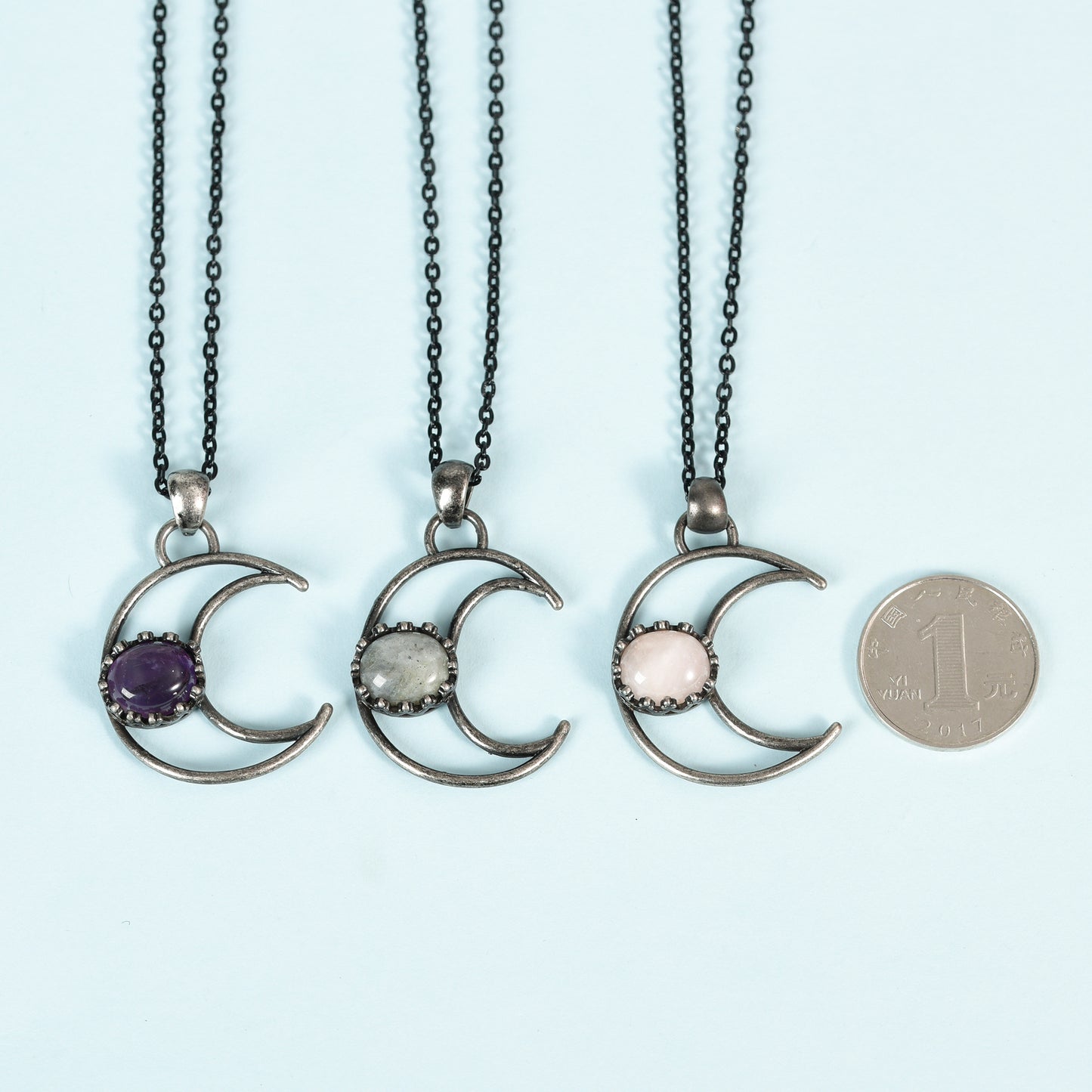 Metal moon with oval crystal pendant