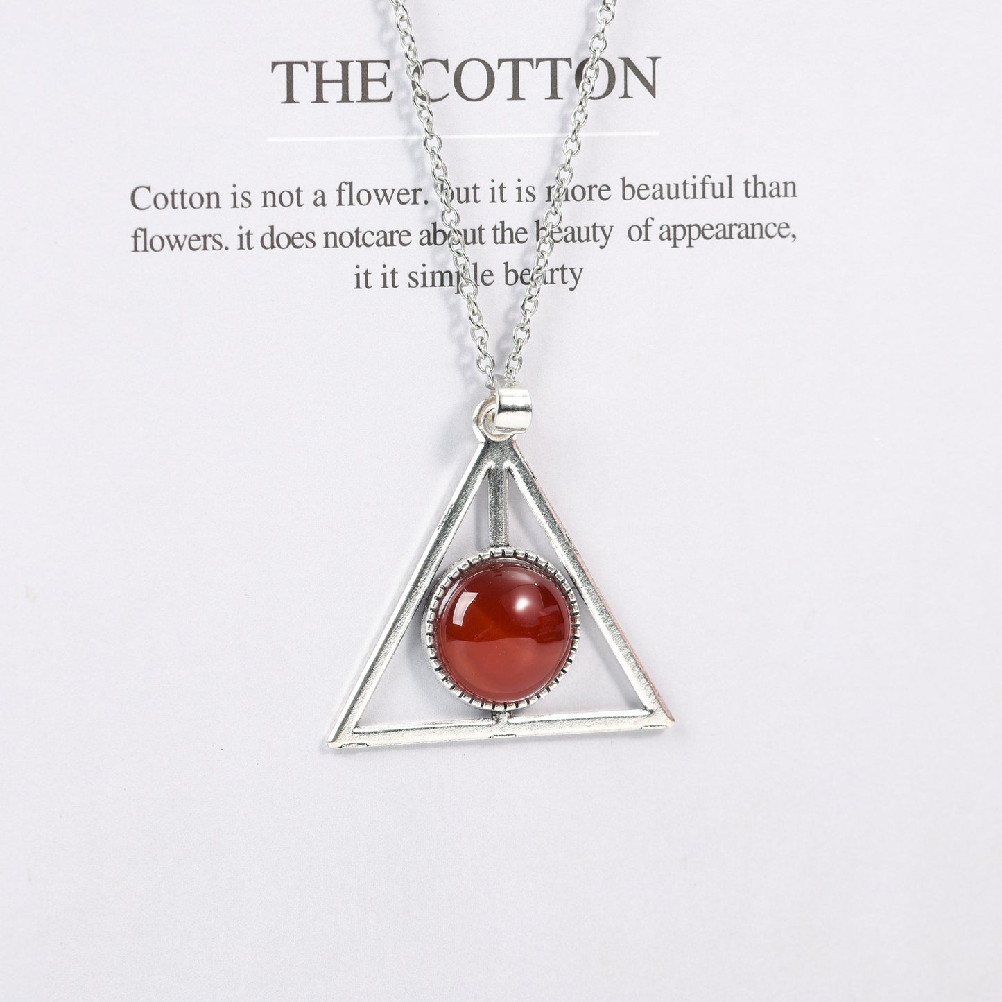 Metal triangle with round crystal pendant