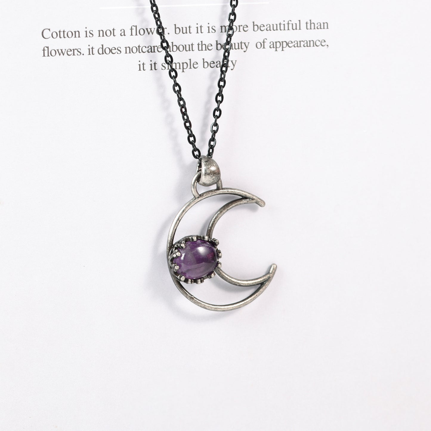 Metal moon with oval crystal pendant