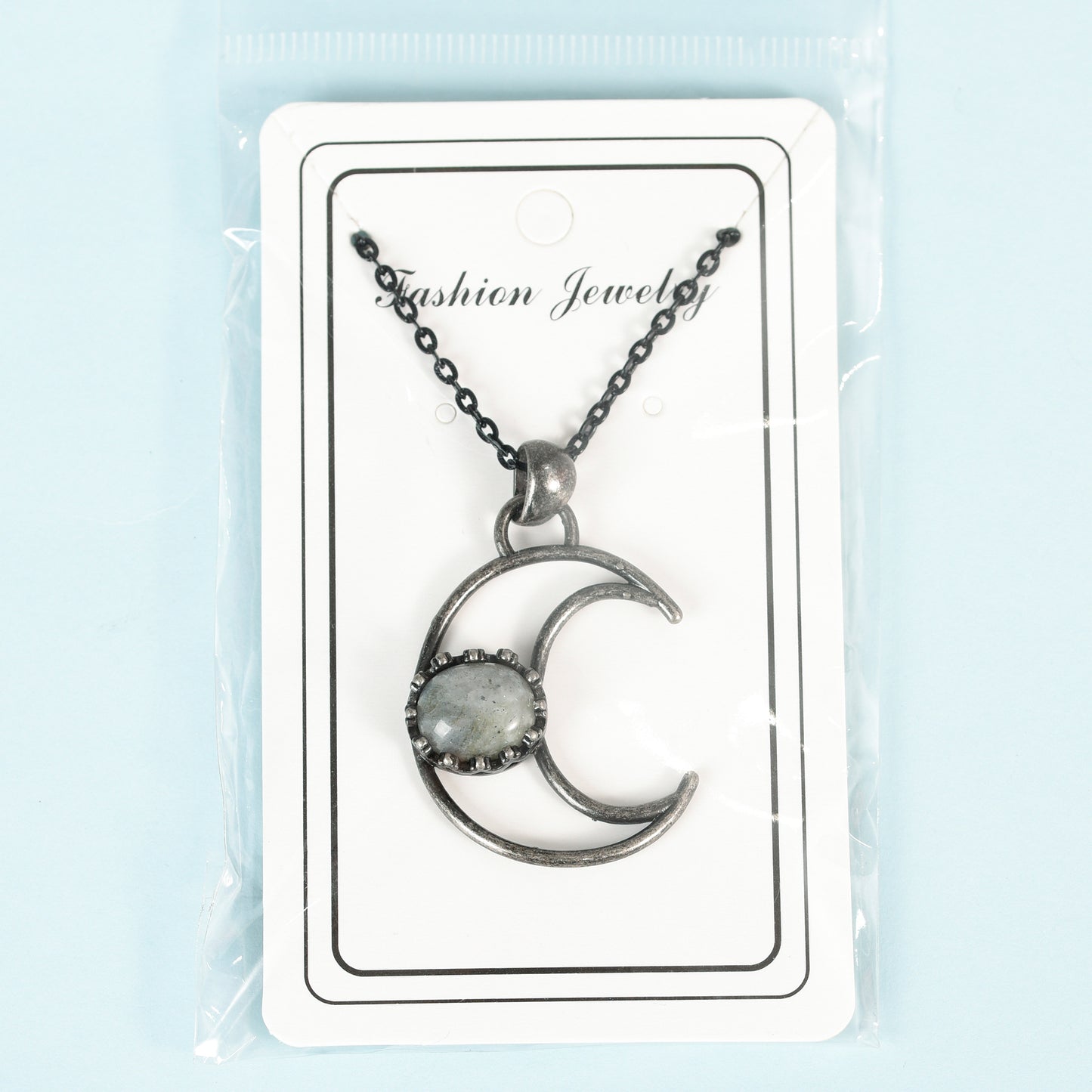 Metal moon with oval crystal pendant